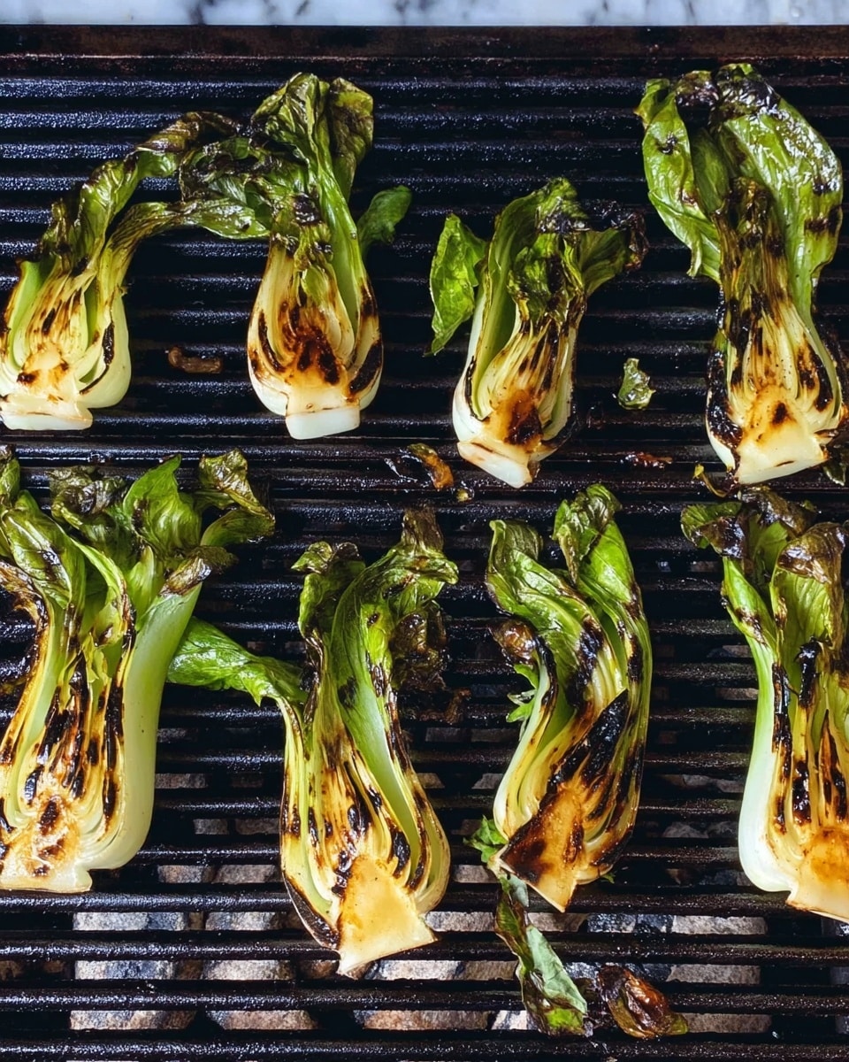 The image shows eight small pieces of bok choy grilled on a black grill rack. Each piece has a white base with green leafy tops that are slightly wilted and darkened from grilling. The bok choy pieces have brown grill marks and charred spots scattered mainly on the white stems and the lower part of the green leaves. The grill bars run horizontally and there are some small bits of food debris on the grill surface. The background is a white marbled texture. Photo taken with an iphone --ar 4:5 --v 7