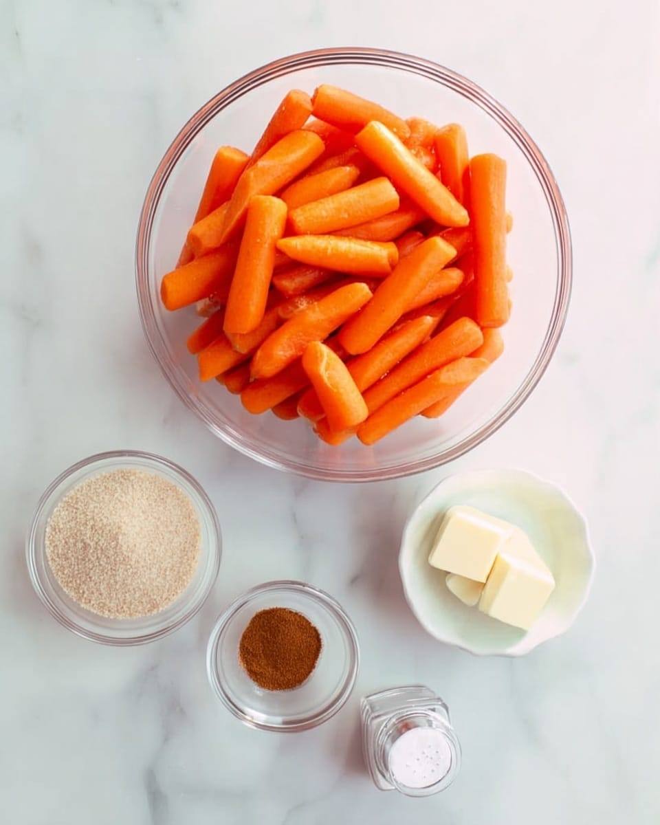 A large clear glass bowl filled with many bright orange baby carrots is placed on a white marbled surface. Around the bowl, there are four small containers: a small clear round bowl with light beige granulated sugar, a small white bowl with brown cinnamon powder, a small white cube of butter, and a small clear salt shaker with white salt. The setup is simple and clean, all items neatly arranged. Photo taken with an iphone --ar 4:5 --v 7