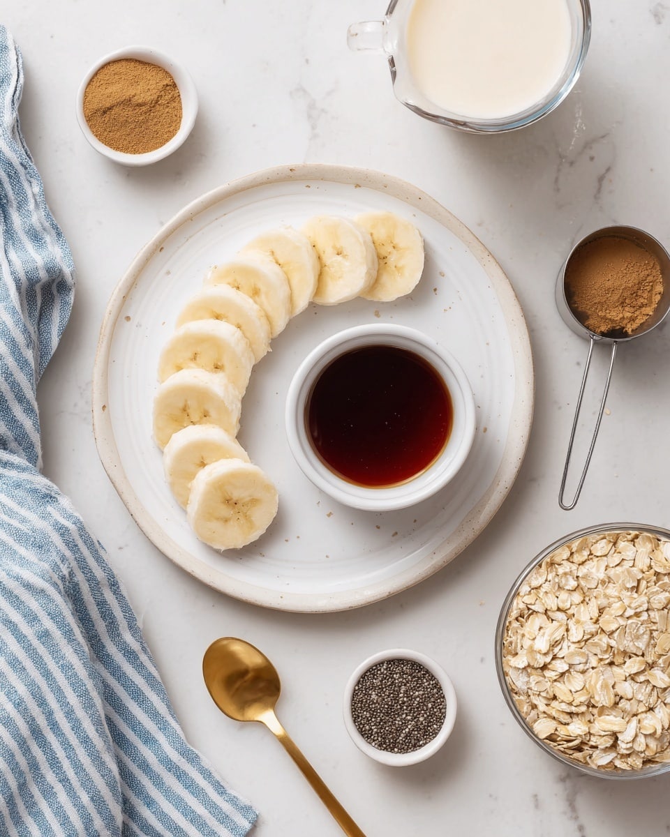 A white plate with a simple pattern holds seven banana slices arranged in a crescent shape on the left side, with a small white bowl filled with dark syrup placed in the middle. Around the plate, on a white marbled surface, there is a glass measuring cup filled with light cream at the top right, a metal spoon with black chia seeds below it, a metal cup filled with light brown oats near the bottom right of the plate, and two small white bowls containing light brown cinnamon powder and dark syrup. A golden spoon lies diagonally near the bottom left corner, and a blue and white striped cloth is draped from the top left corner. photo taken with an iphone --ar 4:5 --v 7