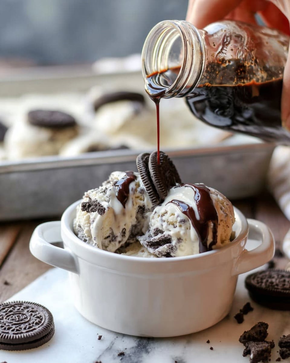 A small white bowl holds three large scoops of white and dark chocolate chip ice cream, topped with a generous drizzle of shiny dark chocolate sauce that pools slightly on top. Two whole dark sandwich cookies lean against the ice cream on one side, adding texture and contrast. The bowl is placed on a wooden surface, with two teal plastic spoons nearby. Photo taken with an iphone --ar 4:5 --v 7