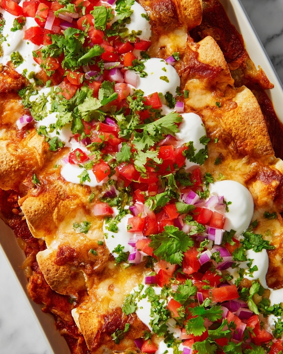 The dish shows a row of golden-brown rolled tortillas lying side by side, each topped with melted cheese that is lightly browned and bubbly. Red sauce covers the tortillas partially, creating a rich, warm base layer. Dollops of white sour cream sit evenly along the top, each garnished with small diced pieces of red tomato, purple onion, and green bell pepper, adding fresh bursts of color. Bright green cilantro leaves are scattered across the whole dish, adding texture and a pop of vibrant green. The dish is set on a white marbled surface. photo taken with an iphone --ar 4:5 --v 7