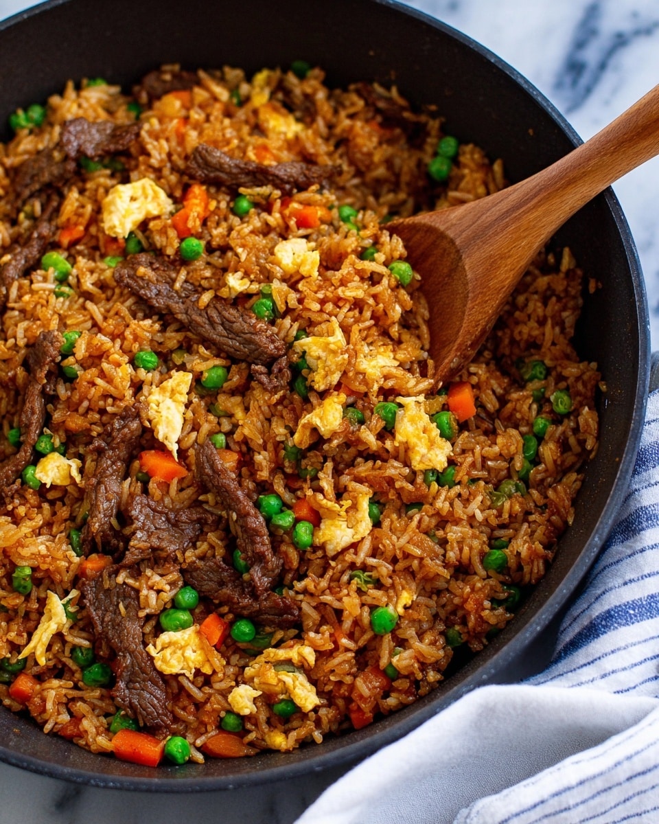 A close-up view of a large black pan filled with fried rice, showing one main layer of cooked brown rice mixed evenly with small pieces of bright orange carrots, green peas, chopped onions, and sliced green onions scattered throughout. There are also thin strips of cooked dark brown beef and chunks of golden yellow scrambled eggs. The pan is placed on a white marbled surface with a white cloth with blue stripes peeking from the bottom right corner. photo taken with an iphone --ar 4:5 --v 7