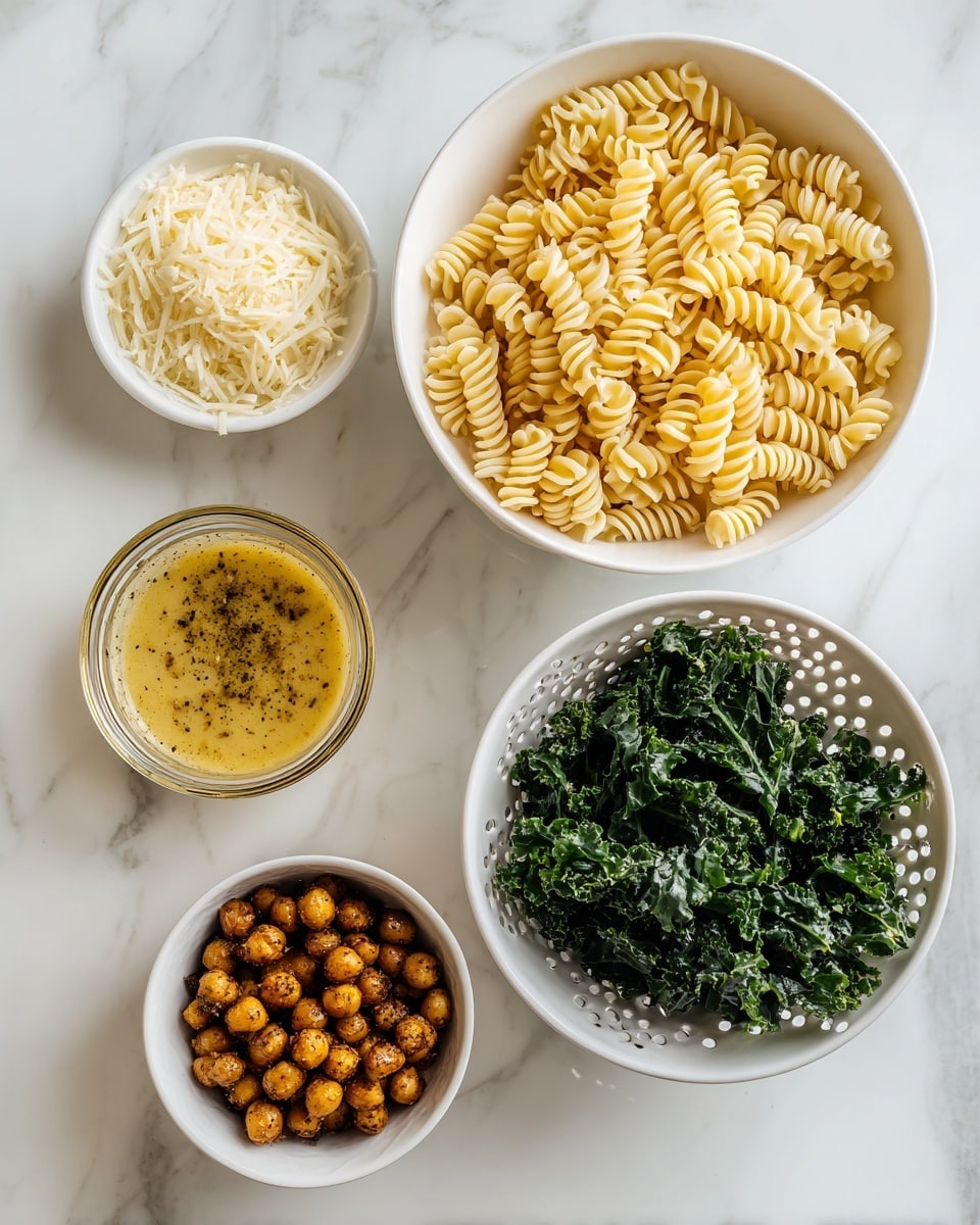 The image shows five white bowls and a colander on a white marbled surface. The white colander at the left bottom holds a layer of light yellow spiral pasta. Above it, a small white bowl is filled with finely grated pale cream Parmesan cheese. To the right of the colander, a small clear glass container holds a thick, mustard-yellow dressing with specks of black seasoning. Below the dressing, a small white bowl contains a layer of dark golden brown roasted chickpeas. At the bottom right corner, a larger white bowl is filled with chopped dark green kale leaves. photo taken with an iphone --ar 4:5 --v 7