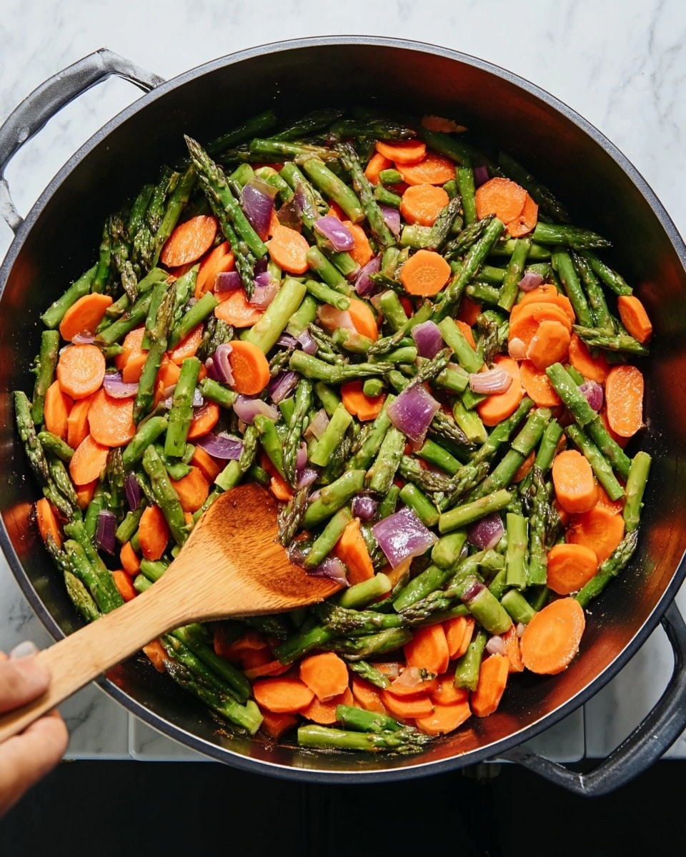 A black pan filled with cooked vegetable pieces, showing three layers: the base layer of dark green asparagus cut into segments, the middle layer of bright orange carrot slices cut into rounds, and the top layer interspersed with small pieces of purple onion, all mixed together. A woman's hand holding a light wooden spoon stirs the vegetables in the pan. The background is a white marbled texture. photo taken with an iphone --ar 4:5 --v 7