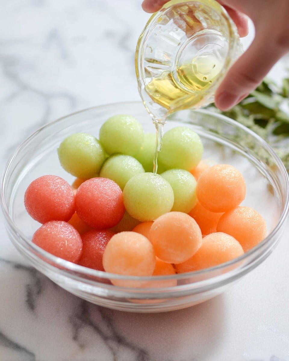 The image shows five halves of melons arranged on a white marbled surface. Two orange melons have smooth, bright orange flesh with a cluster of tan seeds in the center, and a light green rind. Two pink melons feature a softer pink flesh with small dark and light seeds scattered more widely in the center, also with a light green rind. One melon half has light green flesh surrounding a tight cluster of light seeds in the center, with a pale green rind. The texture of the melons is moist and fresh, with clear detail of seeds in each cut. photo taken with an iphone --ar 4:5 --v 7