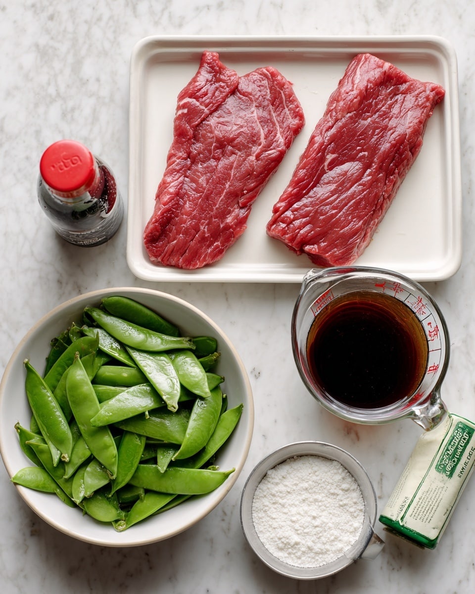 The image shows a white rectangular tray with two raw red beef slices placed side by side, on the left side of the image. To the right, there is a white bowl filled with fresh, green snow peas. Below the bowl and beef, there is a silver measuring spoon filled with white corn starch. Below the spoon, there is a green and white tube of minced garlic. On the top right, there is a bottle of soy sauce with a red cap, and next to it, a glass measuring cup filled with dark brown beef broth. All items rest on a white marbled surface. photo taken with an iphone --ar 4:5 --v 7