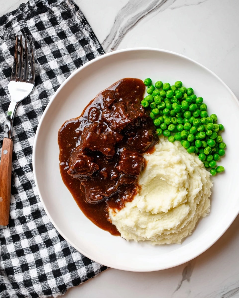 The dish shows a white plate on a white marbled surface with three main parts: a scoop of smooth, creamy mashed potatoes in off-white color placed on the bottom right of the plate, bright green peas grouped tightly next to the mashed potatoes on the top right, and a rich dark brown beef stew with chunks and thick gravy covering part of the mashed potatoes to the left side. The sauce looks glossy and dense, with some small pieces of onion mixed in. A woman's hand holding a fork is resting near the top left side with a black and white checkered napkin under it. Photo taken with an iphone --ar 4:5 --v 7
