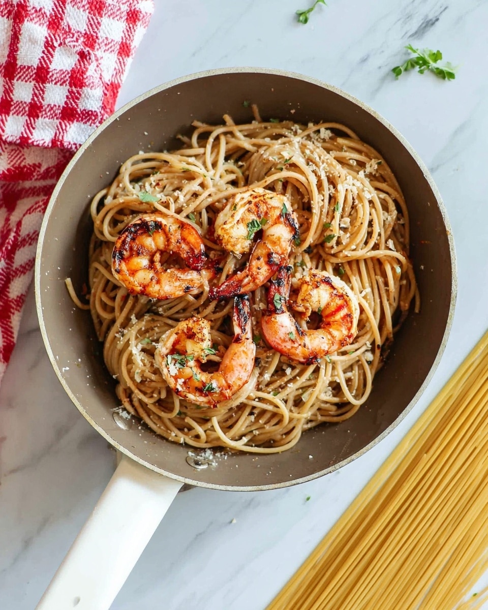 A white plate holds a serving of spaghetti, with three large, grilled shrimp placed on top. The spaghetti is light brown, twisted loosely in the center of the plate with a slight shiny texture indicating a light sauce or oil. The shrimp are orange-red with dark grill marks and a slightly crispy texture. A silver fork is stuck into the spaghetti on the right side of the plate. The plate rests on a white marbled surface. In the background, there are blurred white bowls with lemon slices and green herbs. Photo taken with an iphone --ar 4:5 --v 7