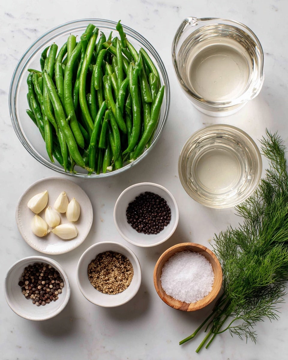 The image shows various ingredients arranged on a white marbled surface. At the top left, there is a clear glass bowl filled with long, fresh green beans. To the right, a clear glass container holds water, and below it is another clear glass container filled with a light-colored vinegar. Several small white bowls are scattered below the larger containers: one has whole coriander seeds, another has black peppercorns, and a third has mustard seeds. There is a small white round dish with several peeled garlic cloves. Additionally, two small wooden bowls hold white sugar and salt. Finally, fresh dill sprigs lay near the bottom right of the image. All items are clearly labeled with black text on white backgrounds. Photo taken with an iphone --ar 4:5 --v 7