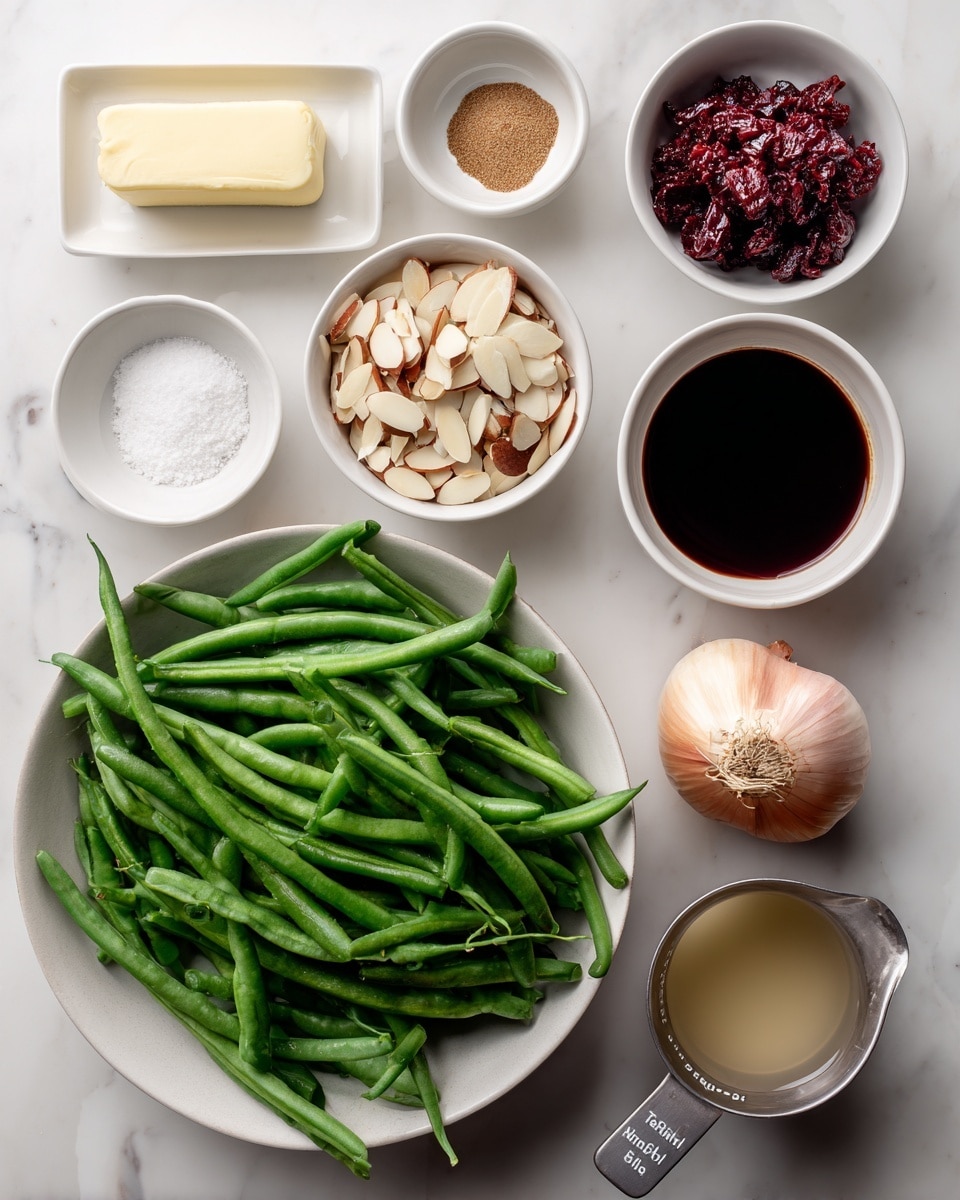 The image shows a top view of various ingredients arranged neatly on a white marbled surface. In the center bottom, there is a large white bowl filled with fresh green beans, long and vibrant green. Around it, smaller white bowls contain different ingredients: chopped almonds with light and dark brown pieces on the left, next to a bowl of coarse white salt below it. Above the almonds, a small bowl holds brown cumin powder. To the top left, a small white dish has a thick square of pale yellow butter. Next to it, a bowl with deep red Calabrian chili paste is placed. Toward the right side, a small white bowl holds dark red wine vinegar, and below it, a metal measuring cup contains light brown chicken broth. A single shallot with light pink skin and a dry stem is in the middle. Each bowl and ingredient is labeled with cursive text, clearly identifying what they are. The whole scene is bright with natural light. Photo taken with an iphone --ar 4:5 --v 7